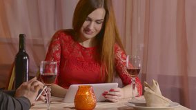 girl and  man with smartphone and tablet in cafe love evening romantic Valentine's Day  4K video 