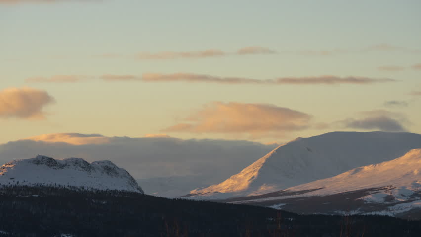 sunset over snowy winter mountain landscape in 4K