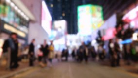 Abstract fast speed video of crowded night city with people walking at street with illuminated modern shopping malls. Hong Kong night life