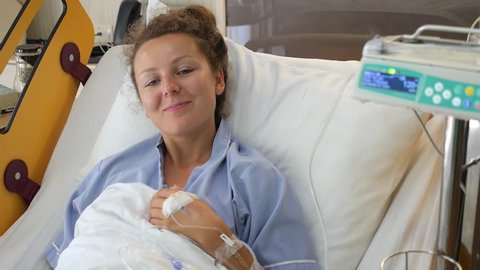 Happy Woman Patient Recovering in Hospital Room with IV Drip