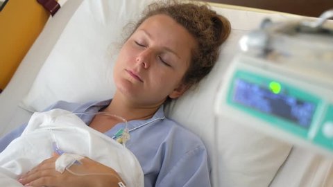 Sick Young Female Patient Suffering in Hospital Room 