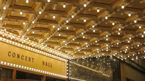 High definition movie of blinking concert hall theater ceiling lights on broadway along a entertainment street 1080p