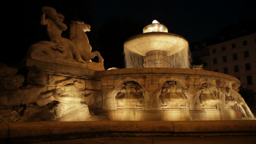 Wittelsbacher Brunnen, a historic monument fountain and landmark of Munich, Germany. Night view of the front side. Wide-angle shot (June 2011, 1080p).