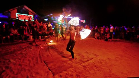 Phi Phi Island, Thailand. February 2016 . Crowd watching an amazing fire performer in Phi Phi Island beach at night.