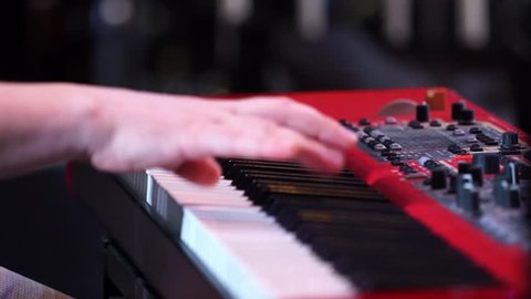 Professional hand playing on keyboard synthesizer