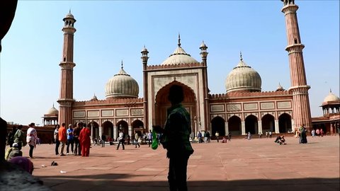 Delhi, India - February 16, 2016: Unidentified visitors in Jama Masjid at morning time in Old Delhi, India. The courtyard of the mosque can hold up to twenty-five thousand worshippers.