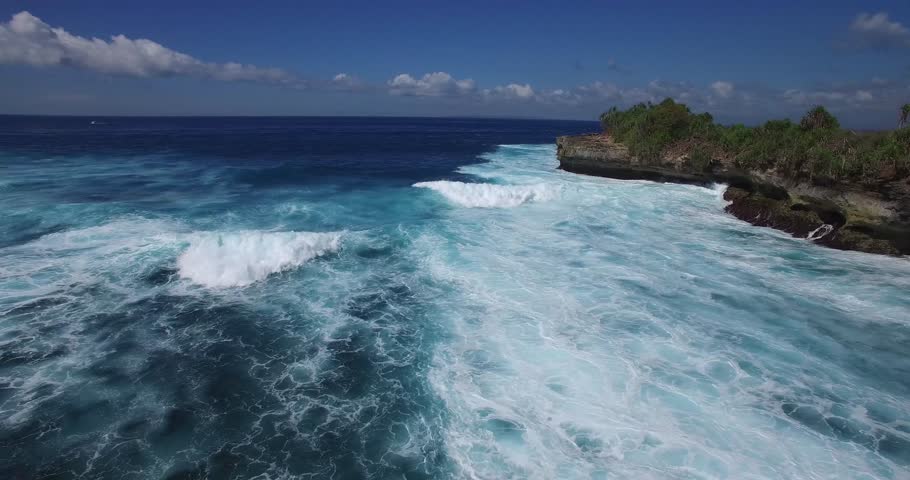 Nusa Lembongan - Bali - Indonesia - DEVILS TEARS - 4K AERIAL PAN AND FOLLOW OCEAN WAVES AS THEY MOVE TOWARDS THE BEACH | Shutterstock HD Video #14597383