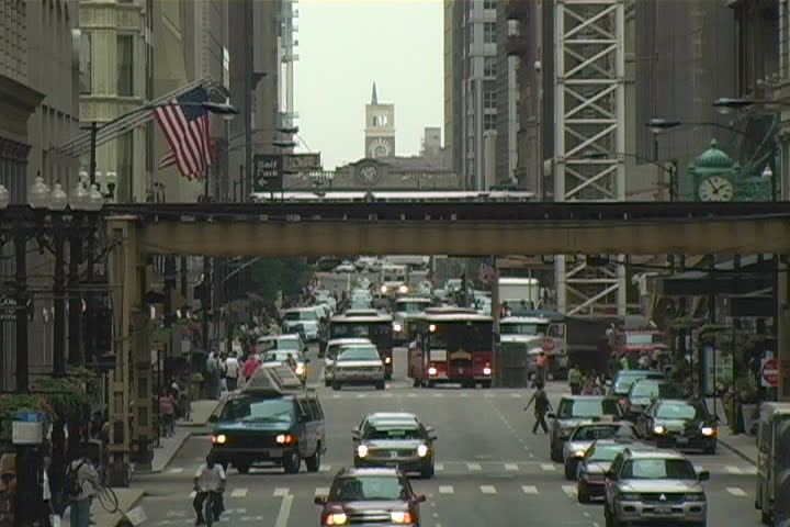 A busy street in downtown Chicago as the El train passes through.