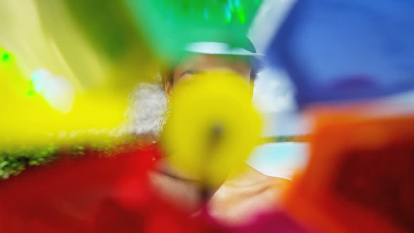 Young African American girl wearing bikini with toy pinwheel on beach