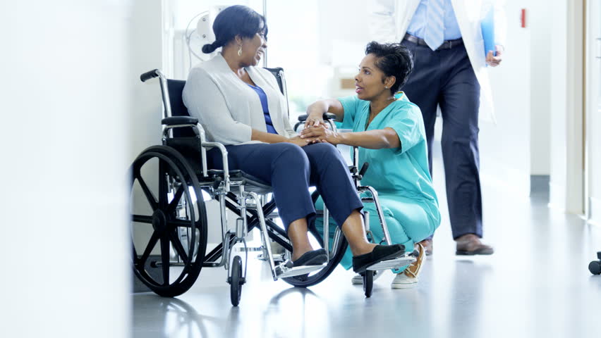 Multi ethnic team and nurse with senior patient on wheelchair in medical center Royalty-Free Stock Footage #14610403