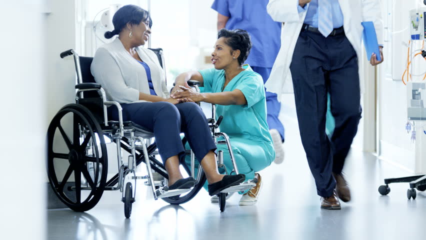 African American female nurse and disabled patient consult in medical center Royalty-Free Stock Footage #14610433