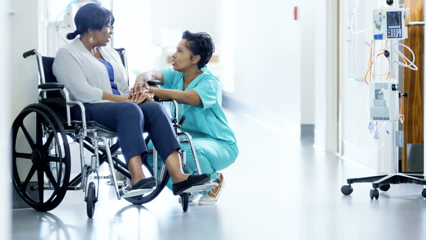 African American female nurse and disabled patient consult in medical center Royalty-Free Stock Footage #14610469