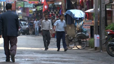 KATHMANDU - CIRCA 2010: People, cars and bikes circulate through the city circa 2010 in Kathmandu.