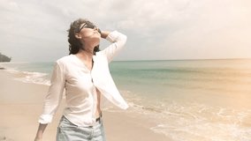 Happy Young Woman Walking on a Beach. Stylized Video