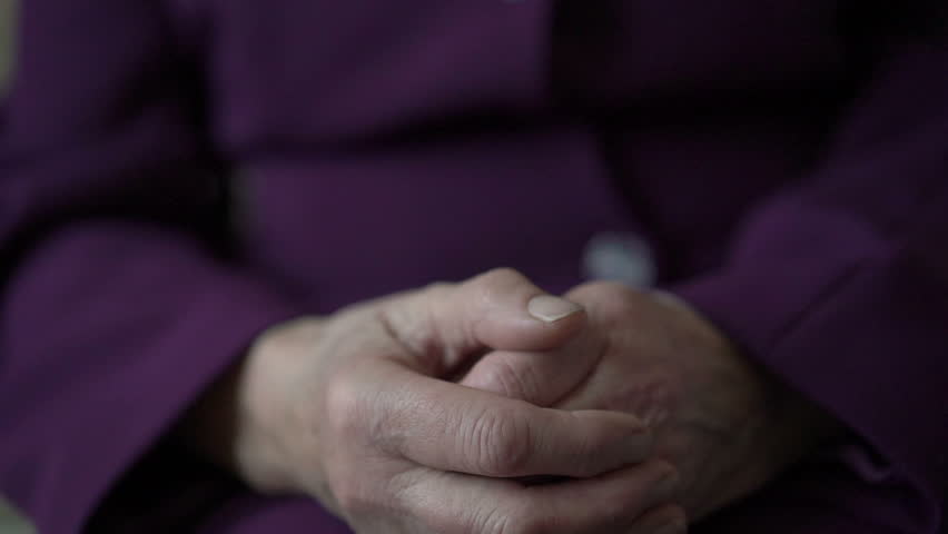 Closeup young hand comforting a old pair of hands. Slowly