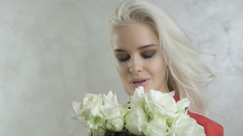 Portrait of Beautiful Young Blonde Woman with Flowers