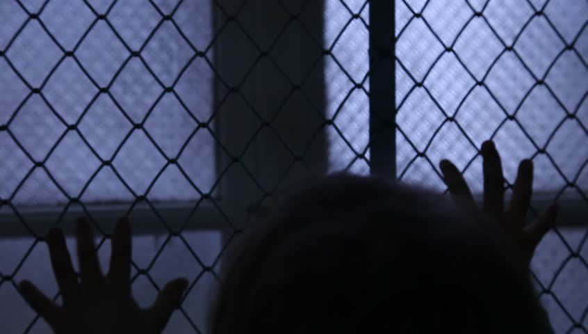 Helpless Child Shaking A Metal Fence Trying To Escape. Silhouette of children hands on the window fence. Refugees or abandoned child. Mental Institution. Family violence. Fingers on the fence Royalty-Free Stock Footage #14627821