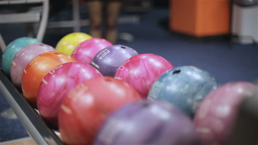Woman takes bowling ball. Close up
