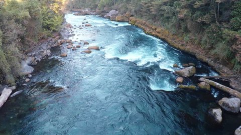 Aerial shot above river whietwater rapids in water of deep blue river in summer in Patagonia Chile - 2K HD