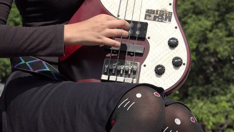 Teen Female Plucking Guitar Strings