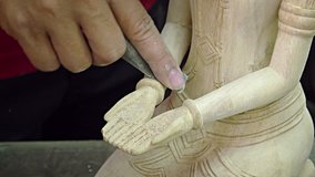 Local. Cambodian artisan works over the fine details of an original. religious sculpture. using sandpaper in his Siem Reap workshop. FullHD video