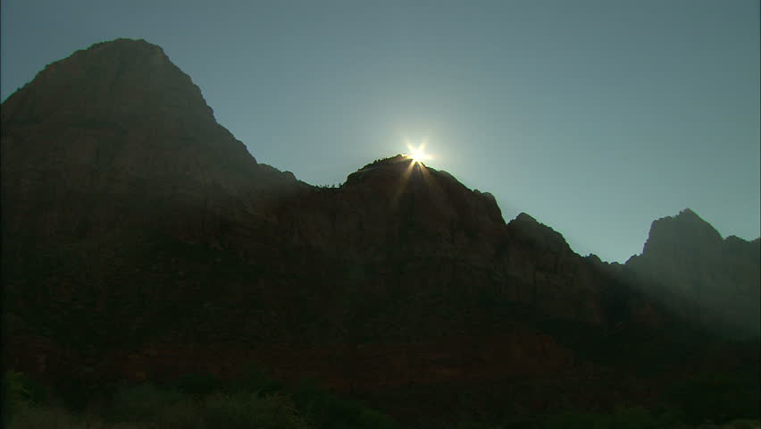 Sun Emerging As Star Burst Over Rocky Peaks and Zion Valley