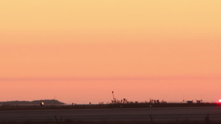 HD footage of a twin engine plane taking off in silhouette against an orange sky. Royalty-Free Stock Footage #1466131