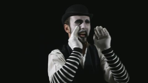 Young hilarious mime shouting using a megaphone
