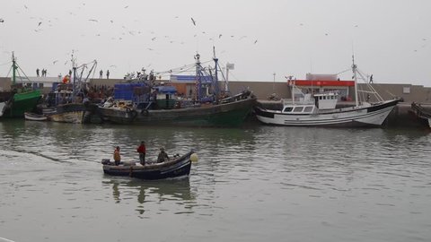fisherman boat foing to sea, essaouira, morocco