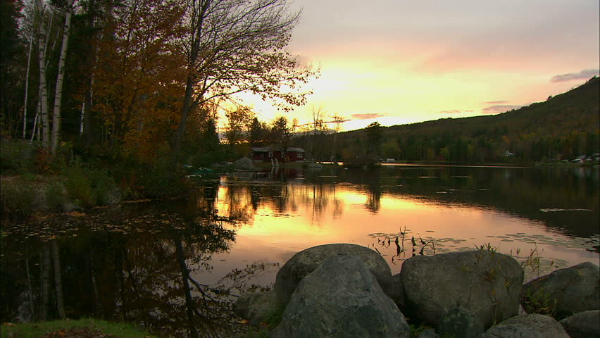 Cabin On The Bank Of Beautiful Pond At Sunset