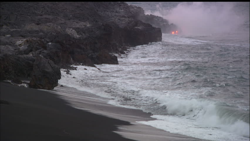 Black Sand Beach With Lava Dripping Into Ocean And Steam, Hawaii