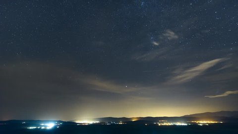 Panning night time-lapse of the moving stars in the summer sky with the rising Moon over the mountains. 