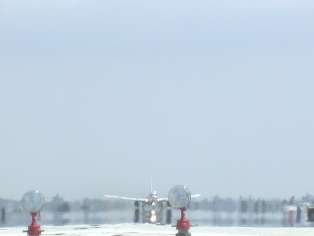 A jet takes off from an airport runway.