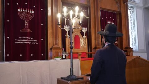 Young orthodox man / rabbi , religious man praying\worshiping in the synagogue