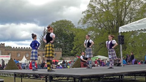 FOCHABERS / SCOTLAND - MAY 17 2015 : Local folks performing the traditional highland dancing on stage