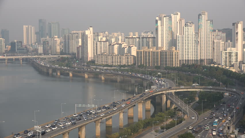 SEOUL, SOUTH KOREA - 7 OCTOBER 2015: Congested highway, commuting morning traffic moves slowly over an elevated road next to the Han river and residential apartment flats, in Seoul, South Korea | Shutterstock HD Video #14677711