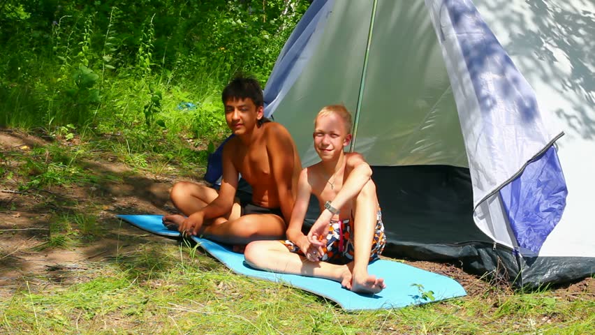 camping children near tent in forest
