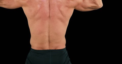 Bodybuilder posing for the camera on black background