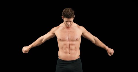 Bodybuilder posing for the camera on black background