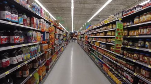 MONTREAL, CANADA - FEBRUARY 2016: Slow Motion: Walking through Walmart aisle (Juices, peanut butter, nutella, milk variety, cereal, tea, coffee)