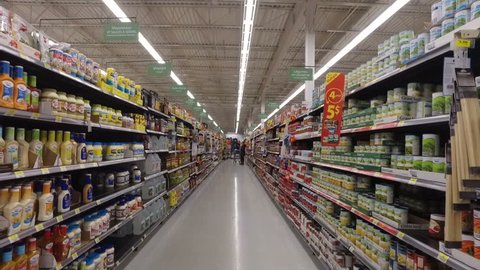 MONTREAL, CANADA - FEBRUARY 2016: Slow Motion: Walking through Walmart aisle (Mayo, oils, food cans, sauces etc.)