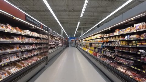 MONTREAL, CANADA - FEBRUARY 2016: Slow Motion: Refrigerator Products at Walmart (Milk, juices, meat, chicken, ham etc.)
