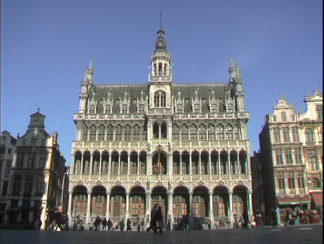 Pedestrians walk by the Grand Place in Brussels, Belgium.