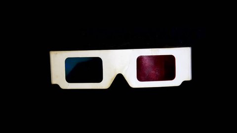 Anaglyph 3-D glasses isolated rotation on black background loop
