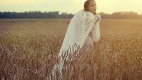 Woman walking in a wheat field. Hand of a young girl touching corn ears in field at sunset in slowmotion. hd, 1920x1080