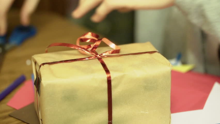 Female hands packing present and making it look perfect
