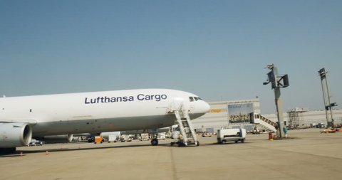 FRANKFURT, GERMANY - CIRCA 2016: Driving through airport with  McDonnell Douglas MD-11F of Lufthansa Cargo plane loading unloading preparing to take off terminal

