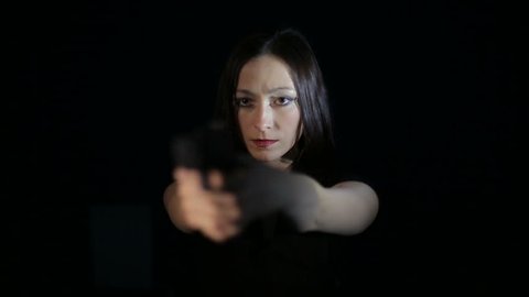 Firearms practice: Woman is shooting from laser gun