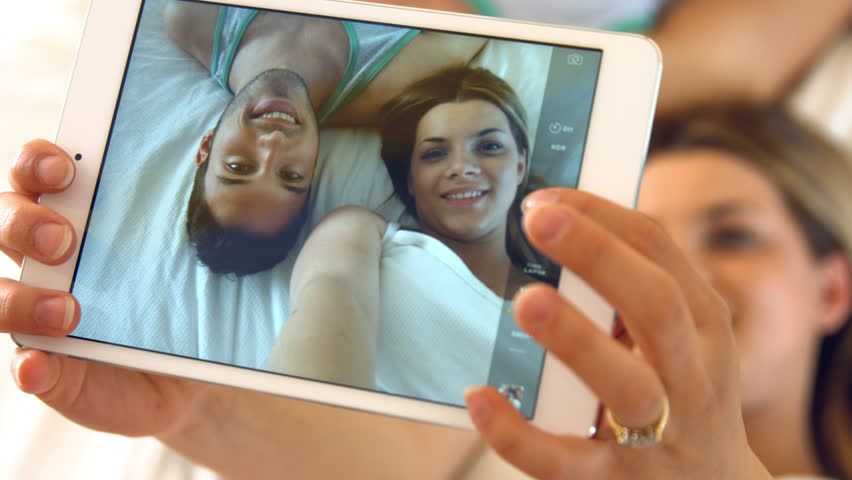Loving couple taking a picture together at home