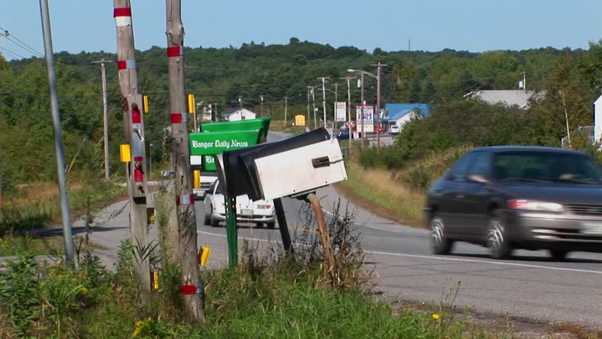 mailboxes are elevated many feet into the sky by wooden polls.